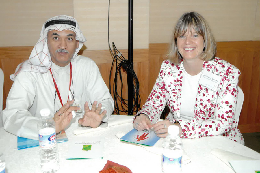 Smiling Gill at table in Kuwait