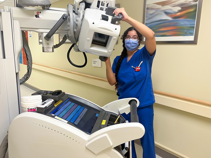 Jessica Hughes, a medical radiation technologist at UHN, moves a portable X-ray machine at Toronto General Hospital.