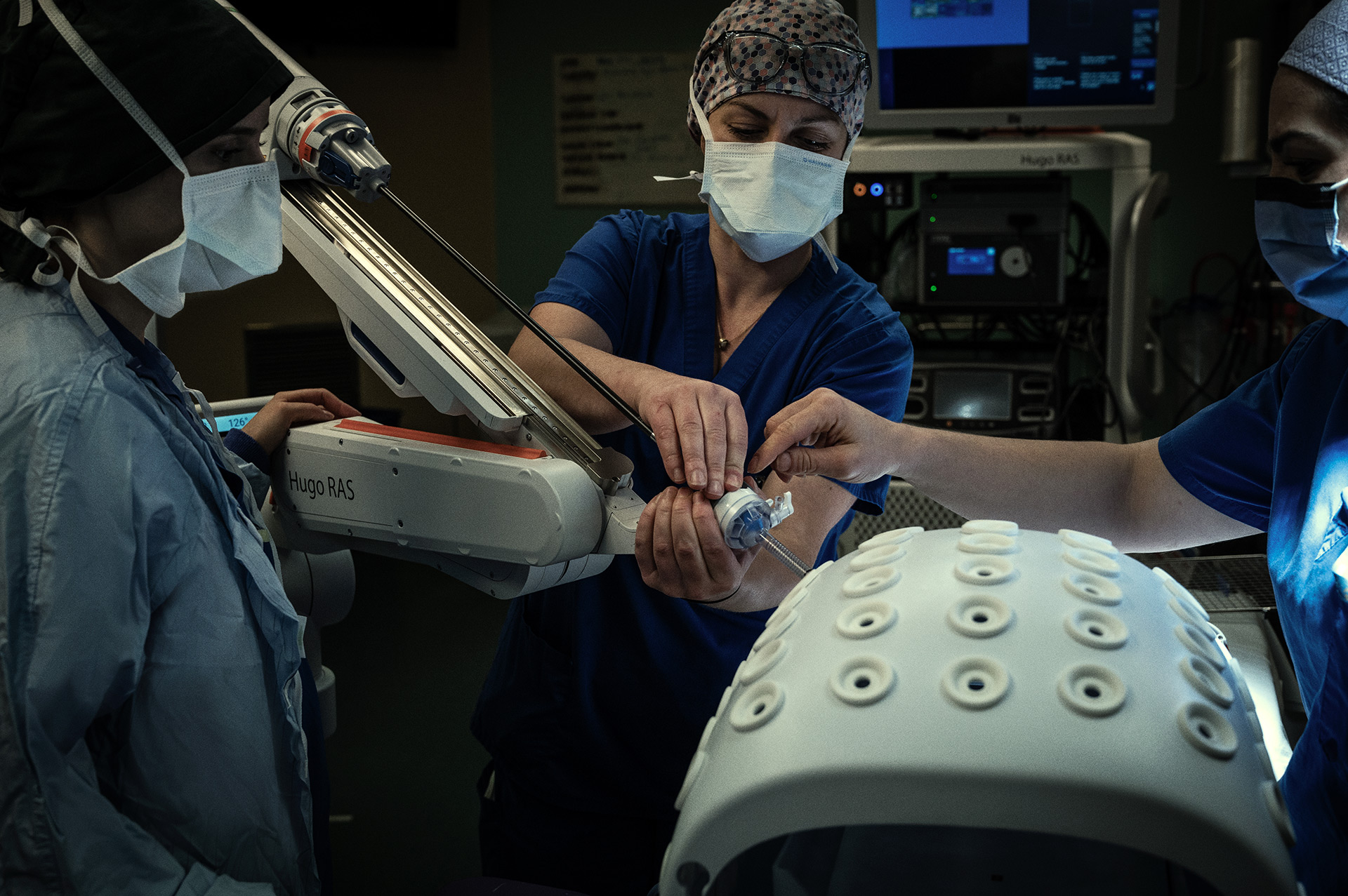 The surgical team preparing one of the surgical robots for a training session. v