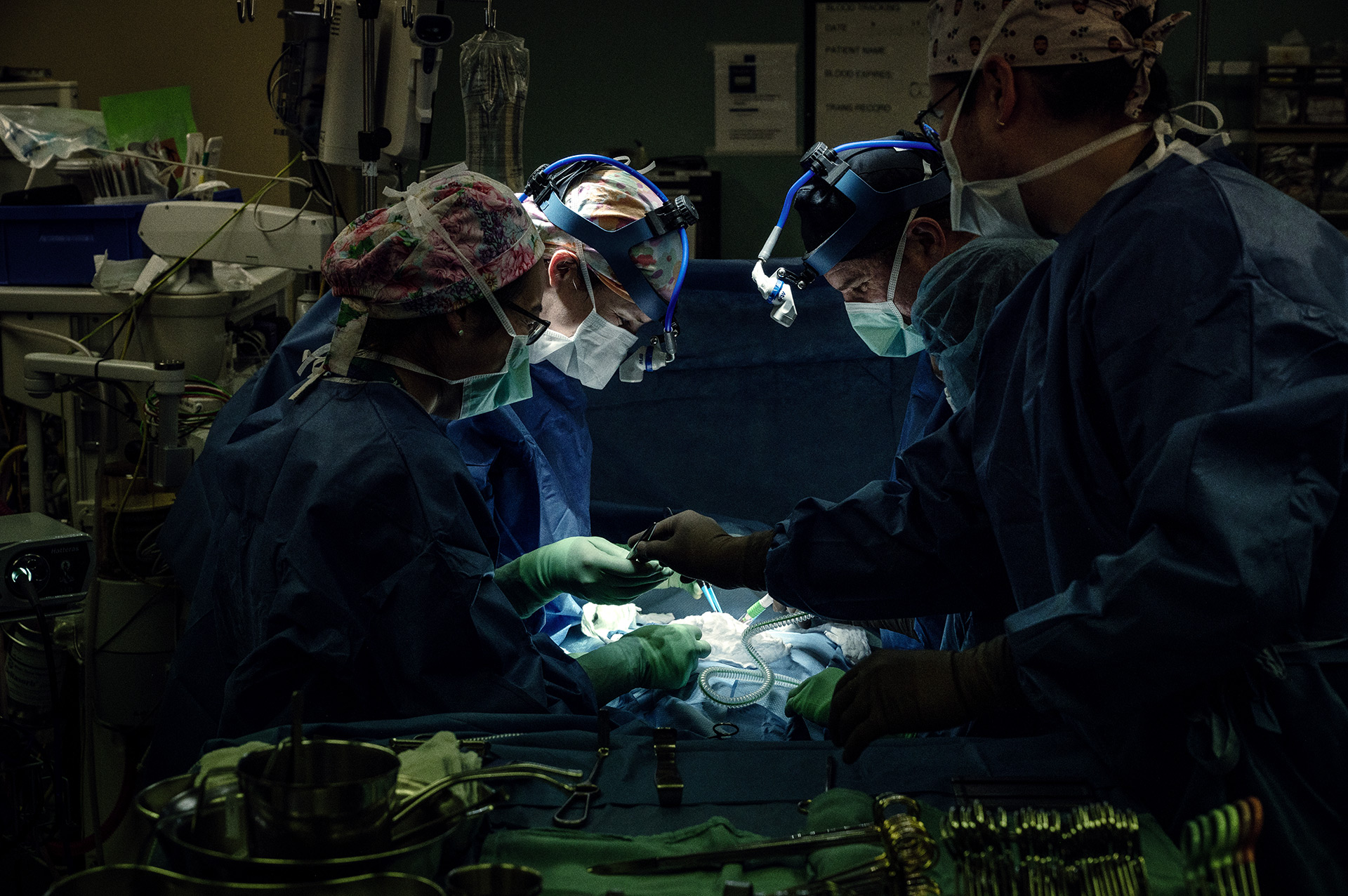 A group of surgeons in a operating room.