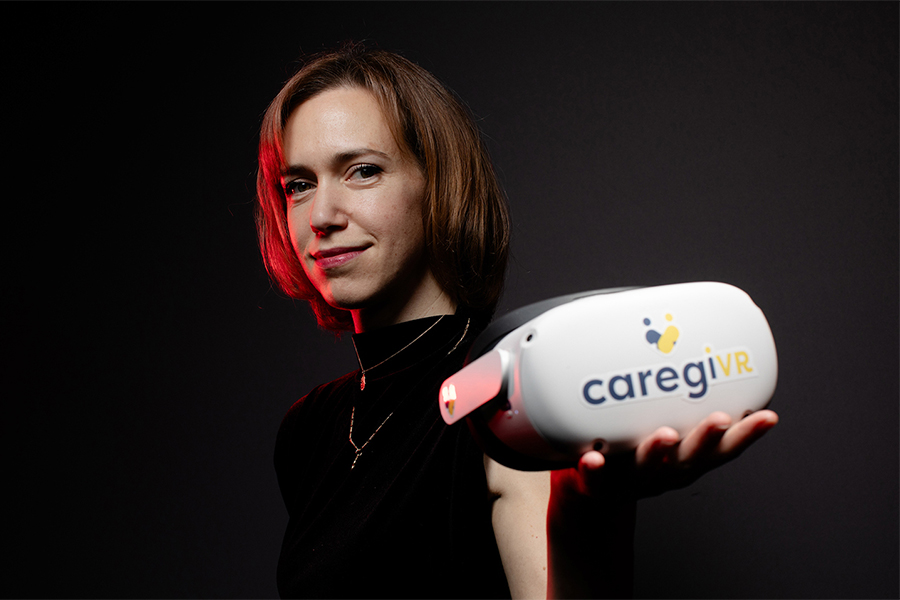 Dr. Lora Appel, an affiliate scientist at UHN's KITE Research Institute, is holding a virtual reality headset.