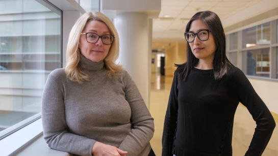 Susan Phillips and Emily Tam from UHN's NEDIC standing in a hallway at Toronto General Hospital