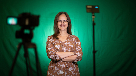 Dr. Andrea Furlan with a camera and green screen