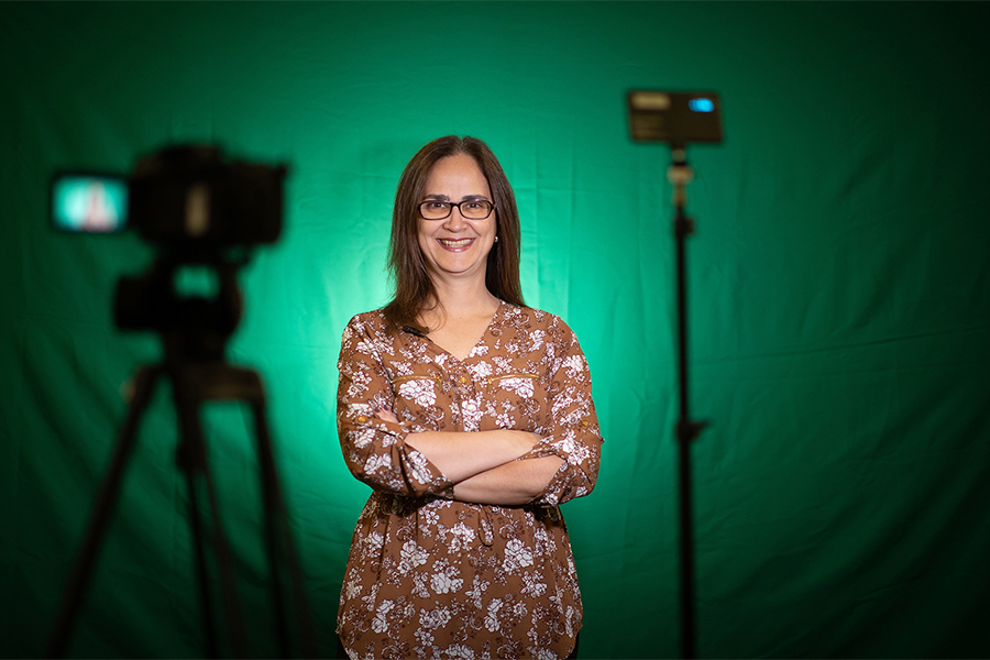 Dr. Andrea Furlan with a camera and green screen