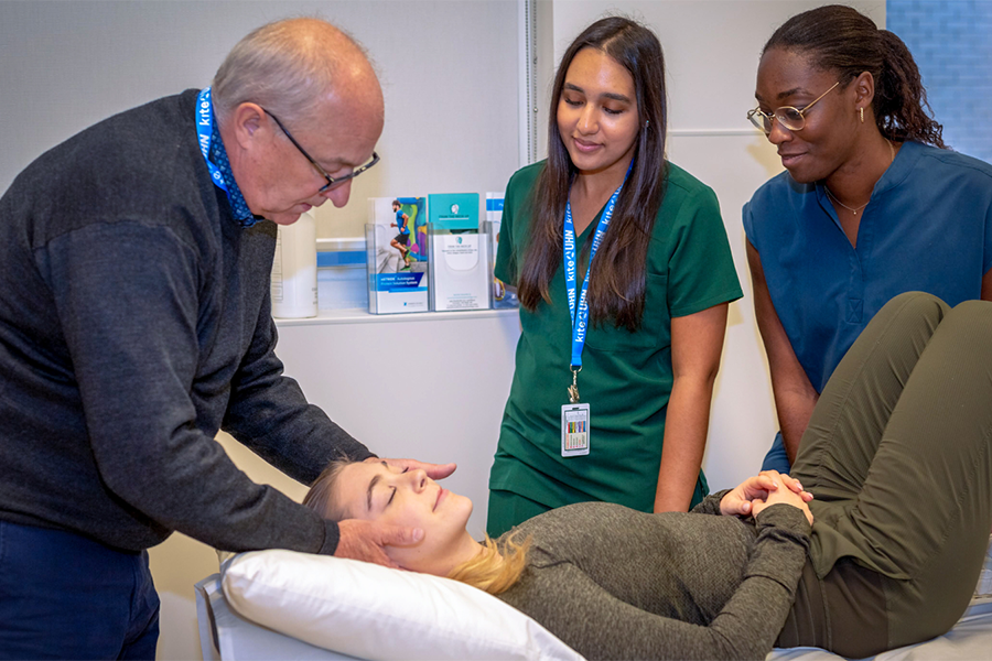 Dr. Ted Crowther, (L), Director of Clinical Education & Patient Care at the Canadian Memorial Chiropractic College, demonstrates the proper technique for students.