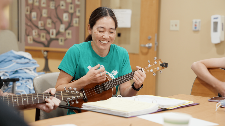 Jennifer Shaw, behavioural specialist at Toronto Rehab plays music with colleagues for patients.