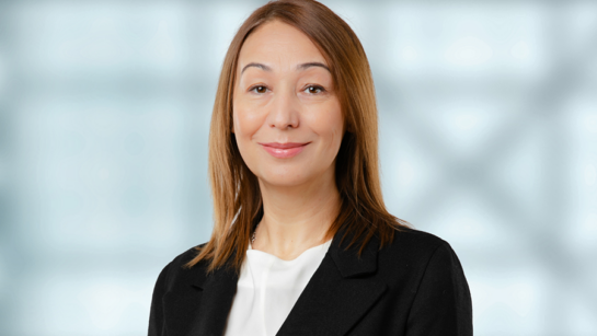 Dr. Tatyana Mollayeva smiling in front of a blurred office background.