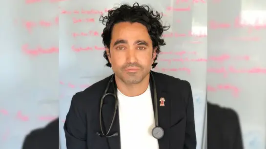 Dr. Andrew Boozary in front of a whiteboard.
