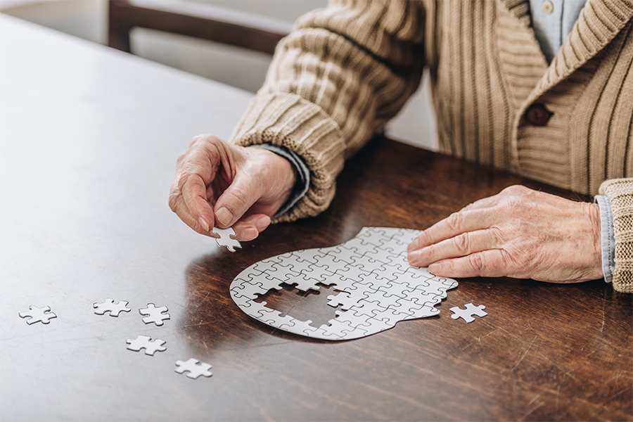 A person completing a puzzle of the human brain.